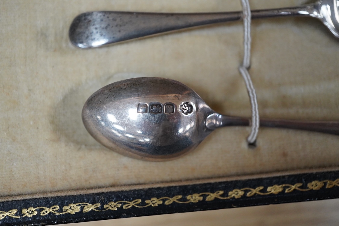 A cased Aynsley coffee set with silver mounted coffee cans and silver teaspoons, William Hutton & Sons, Sheffield, 1924, the leather case 38cm wide